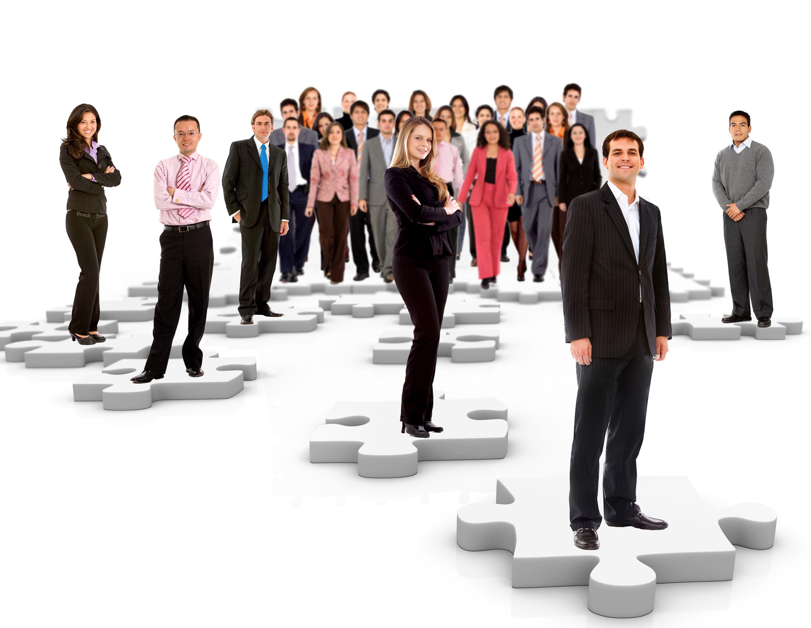 A group of people in an organisation standing on jigsaw pieces